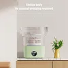 A light green mini washing machine is shown on a countertop, with text describing its features. Náhled obrázku produktu
