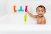 A young child is playing with bath toys in a bathtub. Produktbild-Vorschau