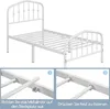 A white metal bed frame with instructional diagrams below. Produktbild-Vorschau