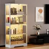 A four-tier glass display cabinet with LED lighting, filled with books and bottles, is shown in a living room setting next to a TV stand and artwork. Náhled obrázku produktu
