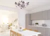 A modern dining room and kitchen area with a floral ceiling lamp. Náhled obrázku produktu