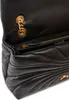 A close-up view of the interior and exterior of a black leather handbag. Anteprima dell’immagine prodotto
