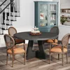 A dining set with a round table and chairs in a room with a staircase and a cabinet. Anteprima dell’immagine prodotto