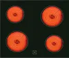 A top-down view of a black glass ceramic stovetop with four heating elements glowing red hot. Produktbild-Vorschau