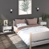 A bedroom scene with a bed, nightstands, and wall art. Produktbild-Vorschau