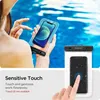 A person holding a waterproof phone case with a phone inside, and another waterproof phone case with a phone inside, with water in the background. Náhľad obrázku produktu