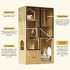 A multi-level cat condo with scratching posts, sleeping areas, and storage, featuring glass doors and ventilation slits. It is presented with descriptive text highlighting its features. Podgląd zdjęcia produktu