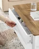 A hand is shown opening a drawer on a white and wood coffee table. Náhled obrázku produktu