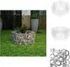 A hexagonal gabion planter filled with stones and plants, situated on a green lawn in a garden setting. Other garden elements like a tall planter and a wooden fence are visible in the background. Wireframe diagrams of the planter are also shown. Podgląd zdjęcia produktu