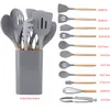 A set of gray silicone kitchen utensils with wooden handles, neatly arranged in a gray holder, with individual utensils and their dimensions displayed to the right. Náhľad obrázku produktu