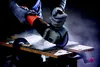 A person wearing gloves is using an angle grinder to cut a piece of material. Produktbild-Vorschau