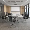 A modern conference room with a long table and chairs, a projector and screen. Produktbild-Vorschau