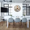 A modern office or meeting room with a large wall clock. Produktbild-Vorschau
