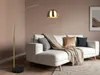 A modern living room with a white sectional sofa and a gold arc floor lamp. Anteprima dell’immagine prodotto