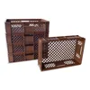 Two stacks of brown plastic crates are shown against a white background. One stack is upright and appears to be a set of nested crates, while the other crate is lying on its side in the foreground. Produktbild-Vorschau