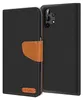 A black flip case for a Samsung Galaxy A32 5G phone, with a brown leather strap and a small brown logo on the front. Podgląd zdjęcia produktu