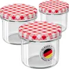Three glass jars with red and white checkered lids are arranged in a group. Produktbild-Vorschau
