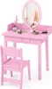 A pink children's vanity table and chair set with a mirror and accessories.