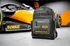 A black and orange Dewalt McLaren rucksack is placed in front of a McLaren Formula 1 car. Podgląd zdjęcia produktu
