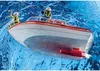 Two figures in yellow jackets and white helmets are on a white and red fire rescue boat in blue water. Produktbild-Vorschau
