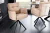 Two beige upholstered chairs with black metal legs are shown in a dining room setting. Produktbild-Vorschau