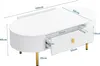 A white oval coffee table with gold legs and drawer handle, shown with dimensions indicated by measurement lines and text. Produktbild-Vorschau