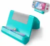 A teal charging dock for a Nintendo Switch Lite is shown, with a smaller inset image of the Switch Lite console itself docked and displaying its screen. Produktbild-Vorschau