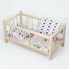 Ein Puppenbett aus Holz in einer natürlichen Farbe mit Produktbild-Vorschau 2