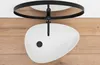 A white vessel sink with a black drain is mounted on a wooden surface, suspended from a black metal frame attached to the ceiling. Náhled obrázku produktu