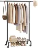 A black rolling garment rack with various clothing items hanging on it and shoes and boxes on the lower shelf. Produktbild-Vorschau