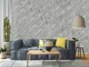 A living room scene with a sofa, coffee table, and decorative wall panels. Produktbild-Vorschau