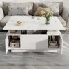 A modern white lift-top coffee table with storage, placed in a living room setting on a gray rug in front of a sofa. Produktbild-Vorschau