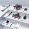 A collection of vacuum cleaner parts and accessories arranged on tiered white surfaces. Voir les images du produit