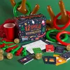 A collection of Christmas-themed party games laid out on a green surface. Produktbild-Vorschau
