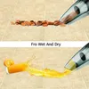 The image shows a handheld vacuum cleaner demonstrating its wet and dry cleaning capabilities on a tiled floor. The top panel shows it cleaning dry debris (nut shells), and the bottom panel shows it cleaning a liquid spill (orange juice). Produktbild-Vorschau