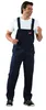 A man wearing navy blue overalls and a white t-shirt, standing against a white background. Produktbild-Vorschau