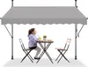 A girl sits at a table under a gray awning. Náhľad obrázku produktu