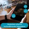 Hands holding a tablet displaying a video, with coffee cups and a notebook on a table. Produktbild-Vorschau