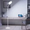 A modern home office setup with a desk, laptop, chair, and a floor lamp. Produktbild-Vorschau