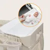 A baby on a changing pad, with a person's hands holding the baby's feet. The changing pad is part of a baby crib/playpen. Produktbild-Vorschau