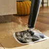 A steam mop is being used on a tiled floor, with steam rising from the mop head. Produktbild-Vorschau