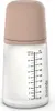 A baby bottle with a beige cap and measurement markings on the side. Produktbild-Vorschau