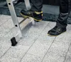 A person wearing safety shoes is stepping onto a ladder. Náhľad obrázku produktu