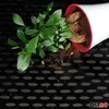 A potted plant has fallen over, spilling soil onto a black textured surface. Voir les images du produit