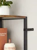 A close-up view of a shelf on a VASAGLE corner shelf unit, showing a book, a decorative jar, and a plant. Náhled obrázku produktu