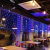 A dimly lit restaurant or cafe interior decorated with blue string lights. Voir les images du produit