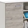Close-up of a wooden cabinet door with a silver handle, next to an open shelving unit with items inside. Produktbild-Vorschau