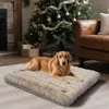 A dog is lying on a dog bed in front of a Christmas tree and a fireplace. Náhľad obrázku produktu