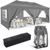 A grey pop-up gazebo tent set up with tables and chairs inside, suggesting an event or party setting. Also shown are the folded tent and a carrying bag. Podgląd zdjęcia produktu
