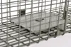 A close-up view of a metal trap mechanism inside a wire cage. Produktbild-Vorschau